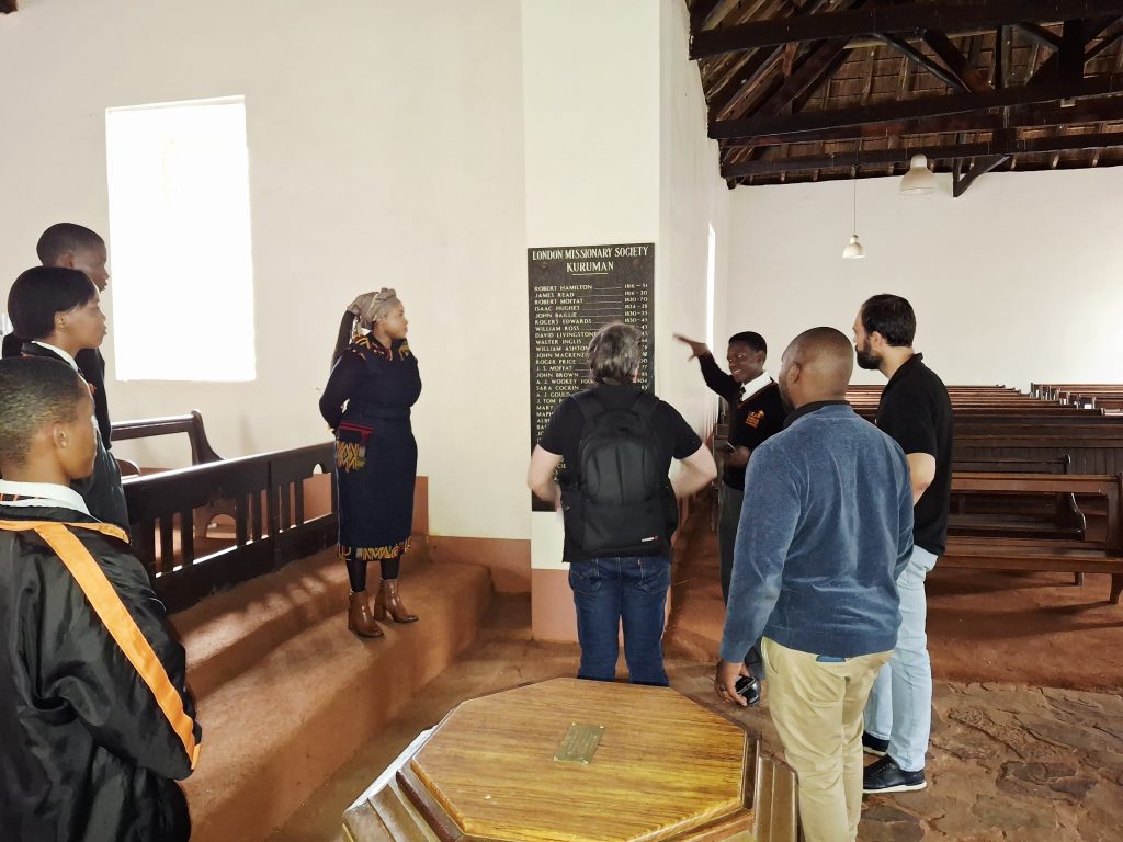 A LEAP Math and Science School student shows the TORSA team the missionaries who offered support to Kuruman.